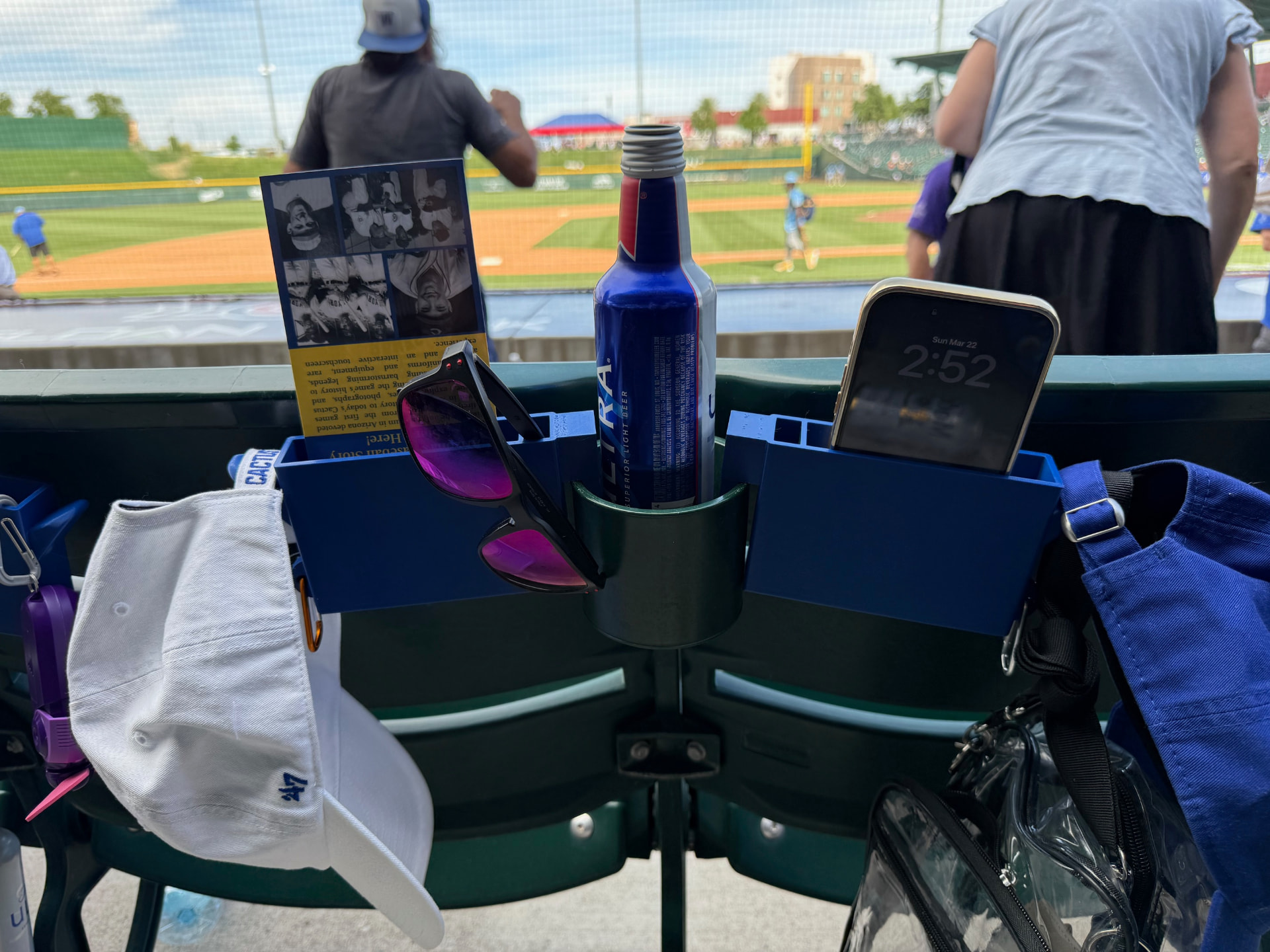 A pair of SNAC-KLIPs mounted on stadium seats at a ballpark
